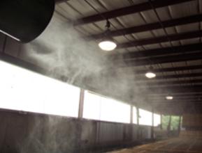 A large building with lots of steam coming out the windows.