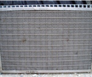 Continuously wetted knitmesh panels flush dirty water to a drain sump at the bottom of the extractor. A radiator that is not working and has been cleaned.