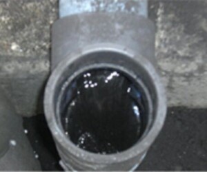 Dirty water flushes out of the sump to the plant drain system or to a water recirculation unit. A pipe that is leaking water from the side of it.