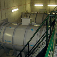 Railway Tunnel Fans A group of tanks in a building with stairs.
